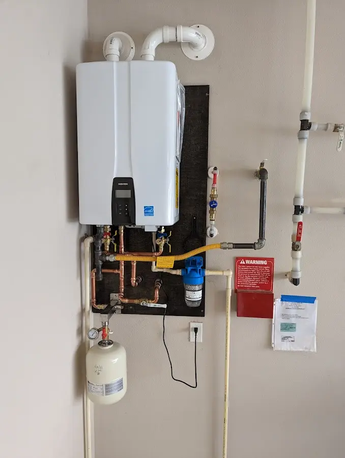 Professional plumber installing copper piping in a Centennial home